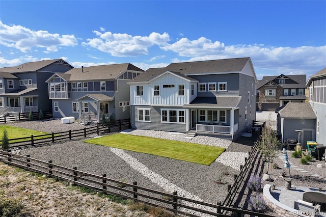 rear view of property with a yard