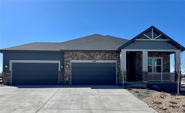 view of front of house with a garage, driveway, a porch, and roof with shingles