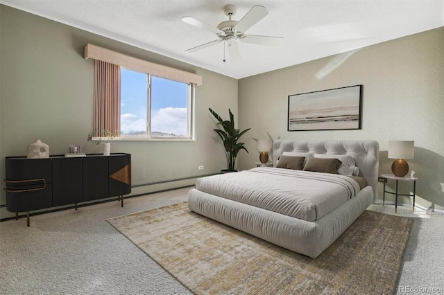 carpeted bedroom featuring a baseboard heating unit and ceiling fan