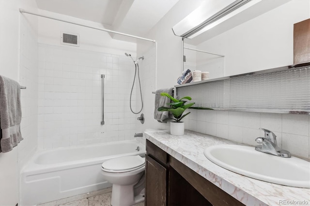 full bathroom with vanity, tiled shower / bath combo, tasteful backsplash, and toilet