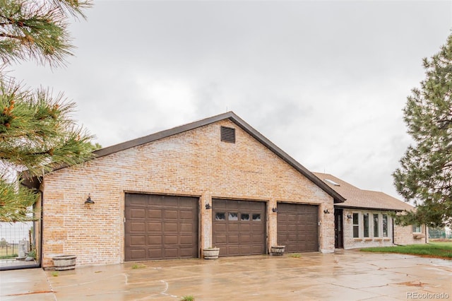 1341 Tomichi Dr, Franktown, CO 80116 - view of front of property featuring brick siding, concrete driveway, and an attached garage