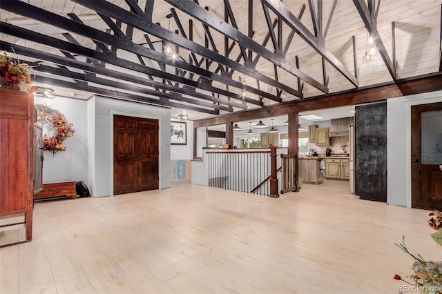 1341 Tomichi Dr, Franktown, CO 80116 - unfurnished living room featuring beamed ceiling, light wood-style flooring, and high vaulted ceiling