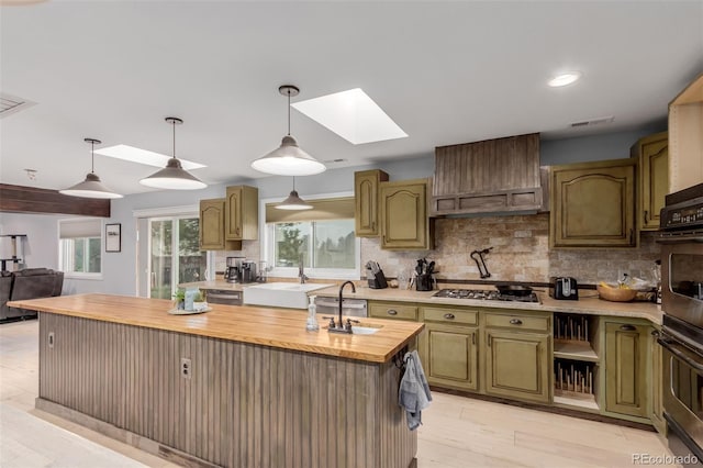 1341 Tomichi Dr, Franktown, CO 80116 - kitchen with a skylight, a sink, wood counters, stainless steel gas stovetop, and recessed lighting