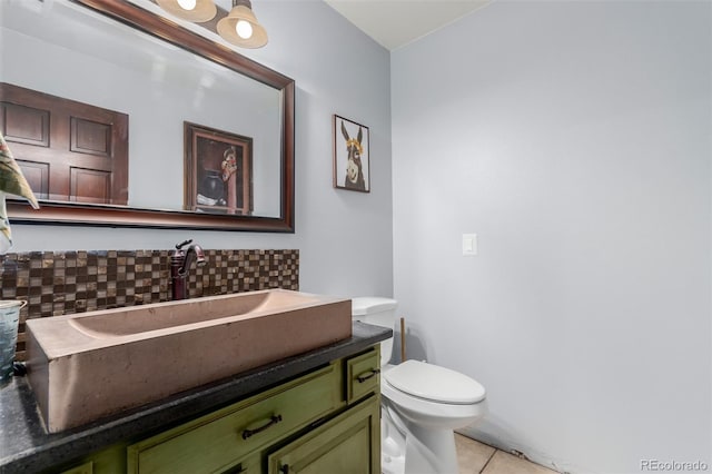 1341 Tomichi Dr, Franktown, CO 80116 - half bath featuring backsplash, tile patterned flooring, vanity, and toilet
