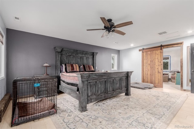 1341 Tomichi Dr, Franktown, CO 80116 - bedroom featuring a barn door, wood finished floors, recessed lighting, and ceiling fan