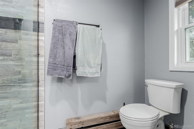 1341 Tomichi Dr, Franktown, CO 80116 - bathroom featuring toilet and a tile shower