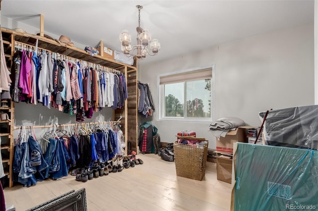 1341 Tomichi Dr, Franktown, CO 80116 - spacious closet featuring a chandelier and wood finished floors