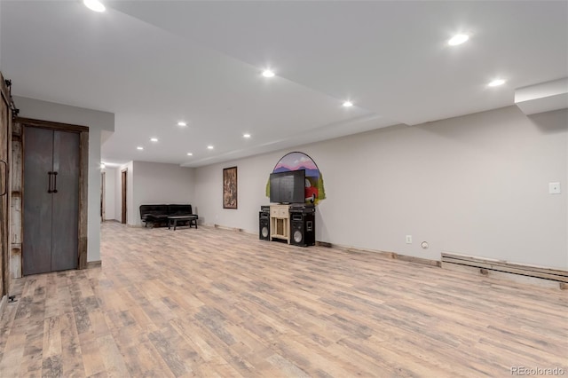 1341 Tomichi Dr, Franktown, CO 80116 - finished below grade area featuring wood finished floors, recessed lighting, baseboard heating, and a barn door