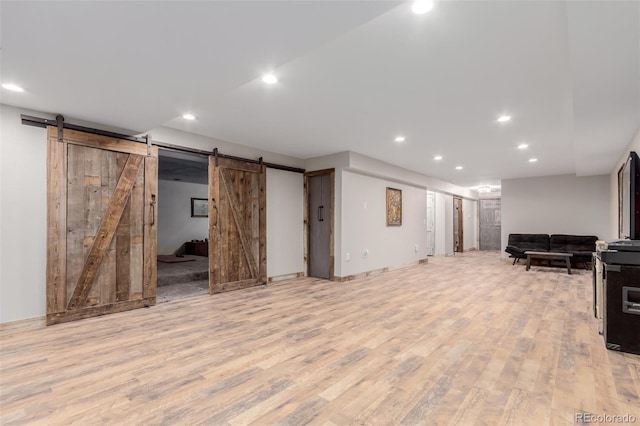 1341 Tomichi Dr, Franktown, CO 80116 - below grade area featuring a barn door, light wood-type flooring, and recessed lighting