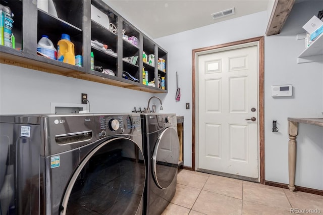 1341 Tomichi Dr, Franktown, CO 80116 - laundry area featuring washing machine and clothes dryer, light tile patterned flooring, and baseboards