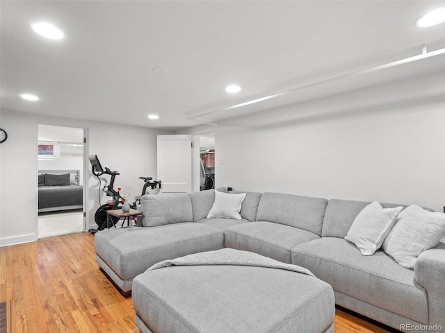 living room with recessed lighting, washer / clothes dryer, and light wood finished floors