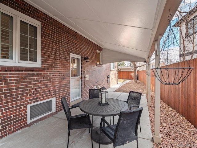 view of patio / terrace with outdoor dining space, a fenced backyard, and visible vents