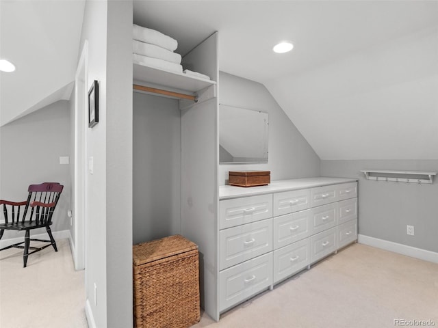 spacious closet featuring lofted ceiling and light carpet