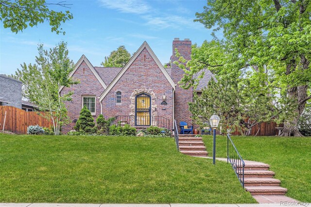 926 S Fillmore Way, Denver, CO 80209 - tudor-style house featuring brick siding and a chimney