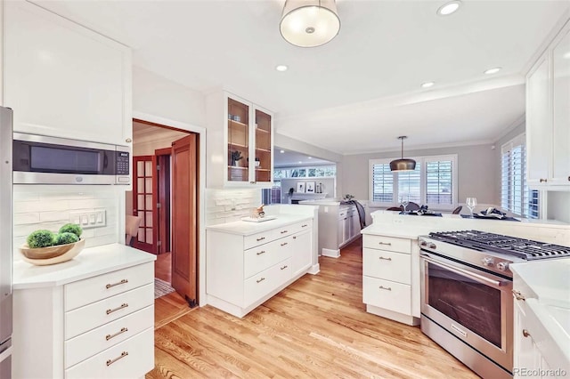 926 S Fillmore Way, Denver, CO 80209 - kitchen featuring stainless steel appliances, white cabinets, light wood finished floors, glass insert cabinets, and recessed lighting