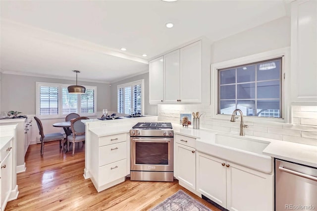 926 S Fillmore Way, Denver, CO 80209 - kitchen featuring stainless steel appliances, a peninsula, crown molding, white cabinetry, and decorative backsplash
