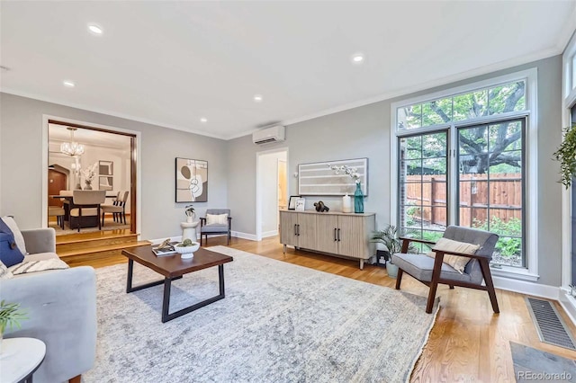 926 S Fillmore Way, Denver, CO 80209 - living area featuring an AC wall unit, light wood finished floors, ornamental molding, recessed lighting, and a chandelier