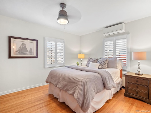 926 S Fillmore Way, Denver, CO 80209 - bedroom featuring a wall mounted air conditioner, light wood-type flooring, ceiling fan, and baseboards