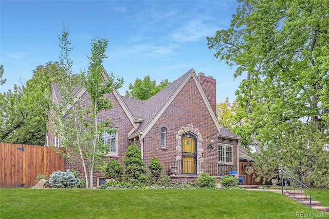 926 S Fillmore Way, Denver, CO 80209 - tudor-style house with brick siding, a chimney, and roof with shingles