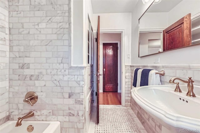 926 S Fillmore Way, Denver, CO 80209 - bathroom featuring tile walls,  shower combination, wainscoting, and a sink