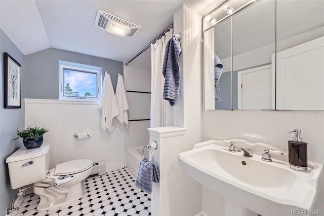 926 S Fillmore Way, Denver, CO 80209 - bathroom with toilet, a baseboard radiator, vaulted ceiling, a sink, and a wainscoted wall