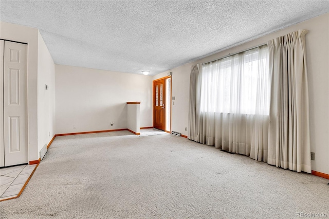 3061 W 92nd Ave Unit 8B, Westminster, CO 80031 - unfurnished room featuring baseboards, a textured ceiling, and light colored carpet