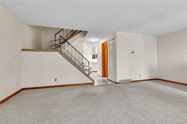 3061 W 92nd Ave Unit 8B, Westminster, CO 80031 - unfurnished living room with visible vents, carpet flooring, and a textured ceiling