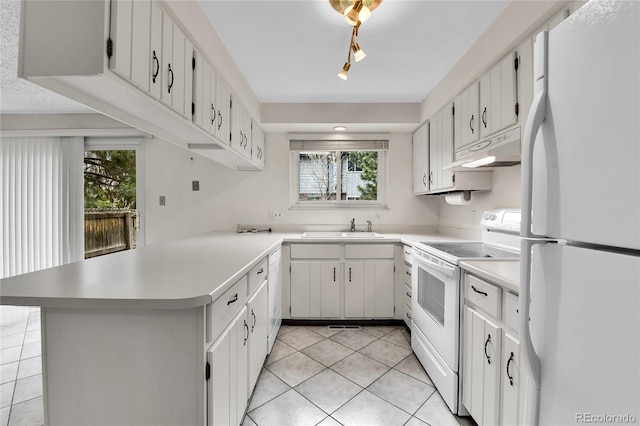 3061 W 92nd Ave Unit 8B, Westminster, CO 80031 - kitchen with a sink, white appliances, a peninsula, light tile patterned floors, and under cabinet range hood