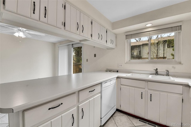 3061 W 92nd Ave Unit 8B, Westminster, CO 80031 - kitchen featuring visible vents, white dishwasher, light tile patterned floors, light countertops, and a sink