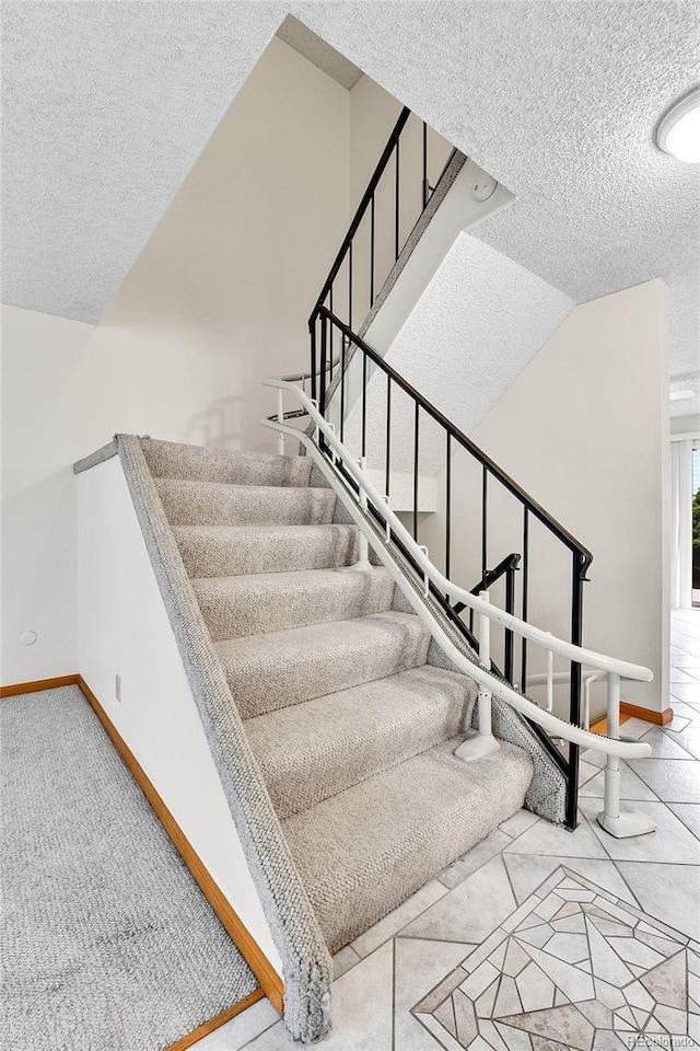 3061 W 92nd Ave Unit 8B, Westminster, CO 80031 - staircase featuring a textured ceiling and baseboards