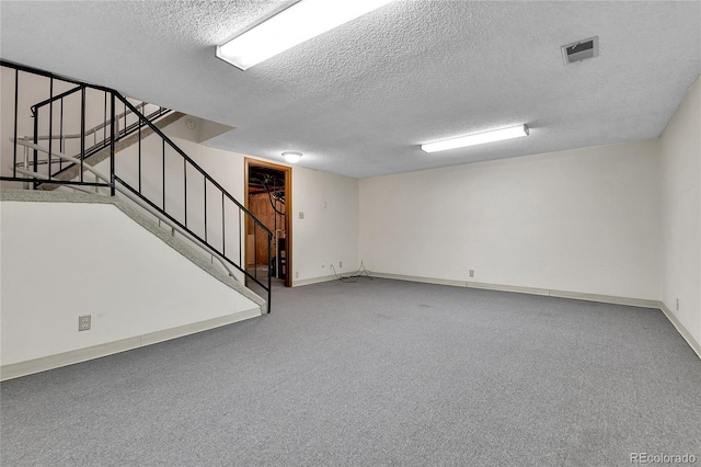 3061 W 92nd Ave Unit 8B, Westminster, CO 80031 - finished below grade area featuring visible vents, carpet flooring, a textured ceiling, and stairway
