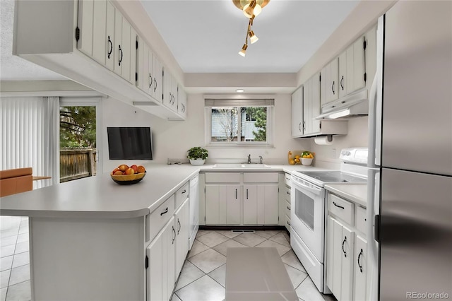 3061 W 92nd Ave Unit 8B, Westminster, CO 80031 - kitchen featuring light tile patterned flooring, a sink, white appliances, a peninsula, and under cabinet range hood
