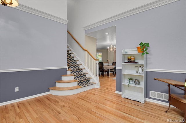 9665 Whitecliff Pl, Highlands Ranch, CO 80129 - stairway featuring a chandelier, wood finished floors, and baseboards