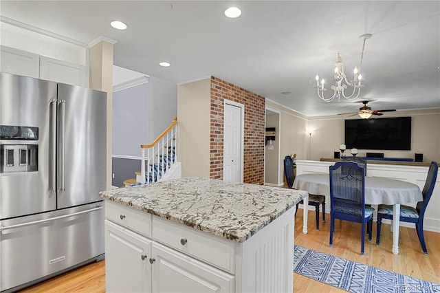9665 Whitecliff Pl, Highlands Ranch, CO 80129 - kitchen with high end refrigerator, a ceiling fan, a chandelier, open floor plan, and a kitchen island