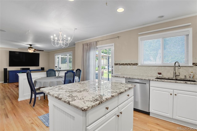 9665 Whitecliff Pl, Highlands Ranch, CO 80129 - kitchen with stainless steel dishwasher, a sink, ornamental molding, light wood-style flooring, and tasteful backsplash