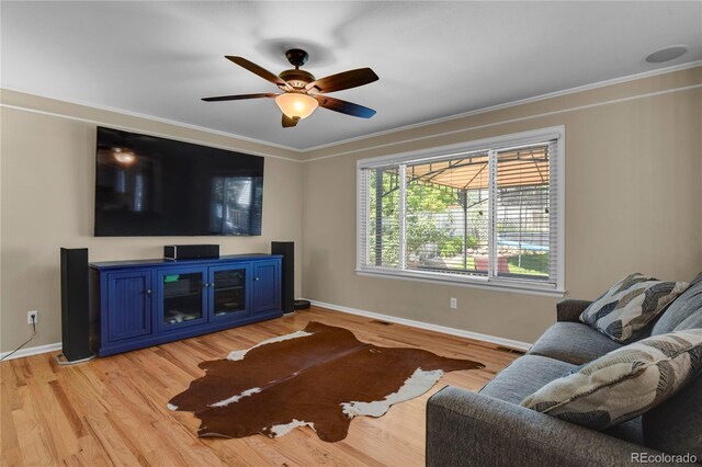 9665 Whitecliff Pl, Highlands Ranch, CO 80129 - living area featuring baseboards, a ceiling fan, light wood-style flooring, and ornamental molding