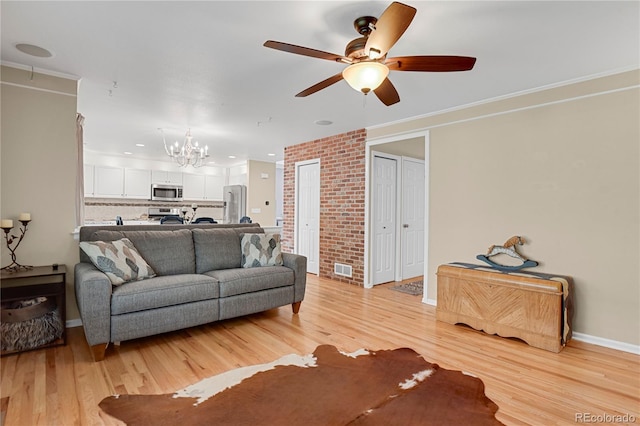 9665 Whitecliff Pl, Highlands Ranch, CO 80129 - living area with a chandelier, light wood-style floors, ceiling fan, baseboards, and ornamental molding