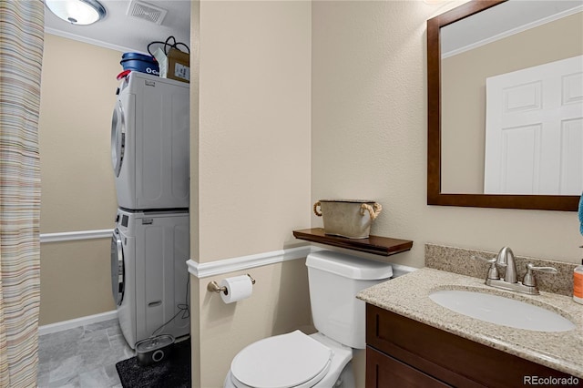 9665 Whitecliff Pl, Highlands Ranch, CO 80129 - full bath featuring estacked washer and dryer, ornamental molding, toilet, vanity, and baseboards
