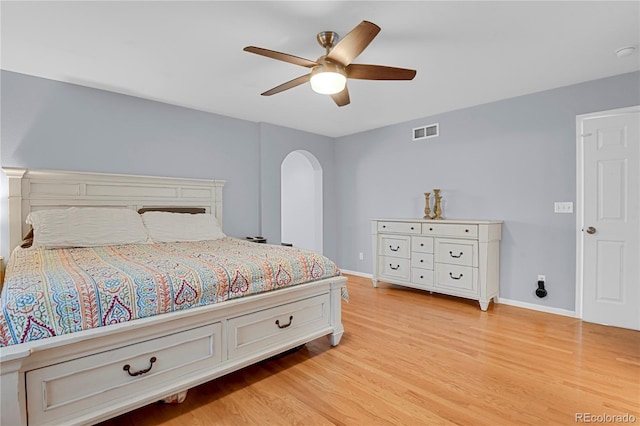 9665 Whitecliff Pl, Highlands Ranch, CO 80129 - bedroom with arched walkways, light wood finished floors, baseboards, and ceiling fan