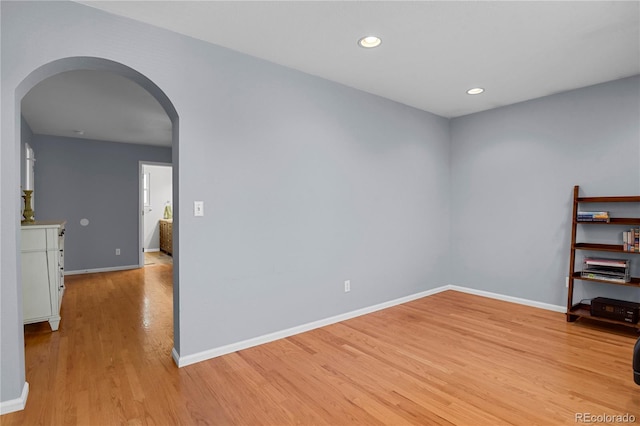9665 Whitecliff Pl, Highlands Ranch, CO 80129 - spare room with arched walkways, light wood-type flooring, baseboards, and recessed lighting