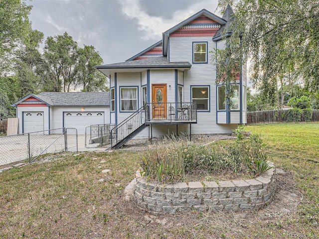 view of front of house featuring a garage and a front lawn