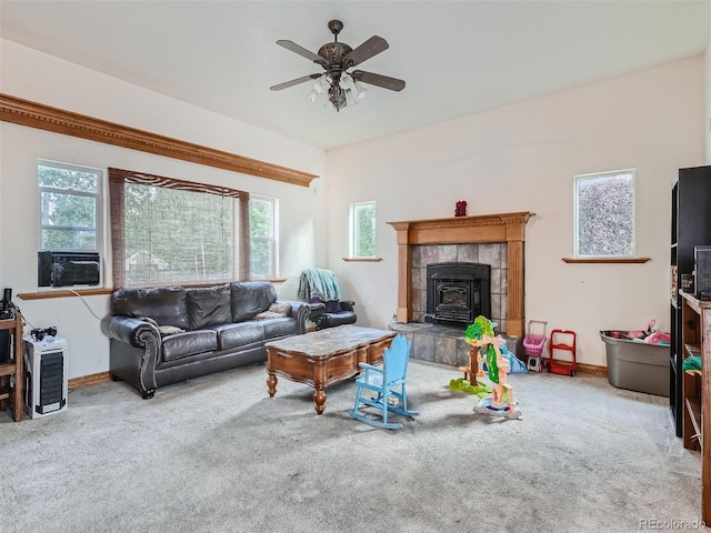 carpeted living room featuring ceiling fan and a tile fireplace