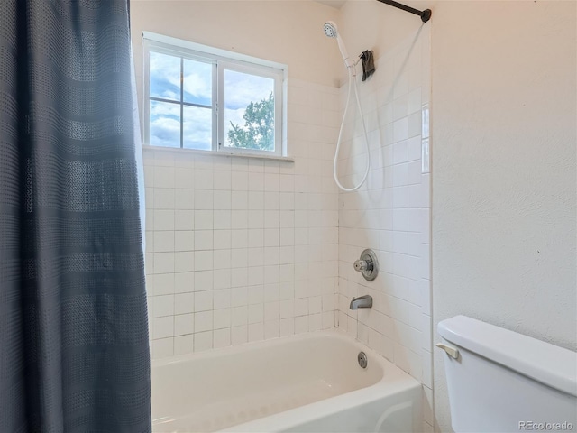 bathroom featuring toilet and shower / bath combo with shower curtain