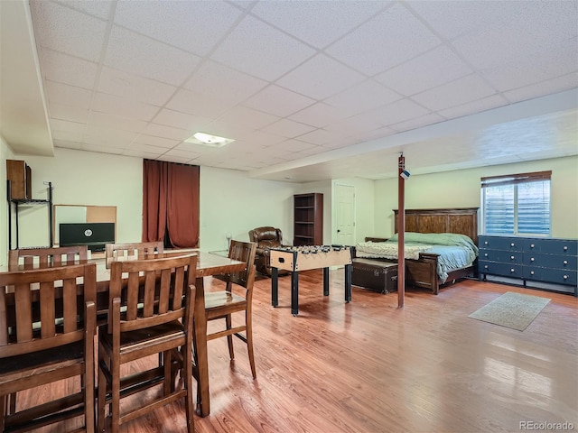 dining space featuring a paneled ceiling and hardwood / wood-style flooring