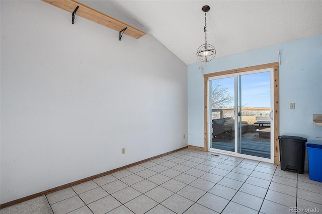 empty room with light tile patterned flooring, a chandelier, and vaulted ceiling