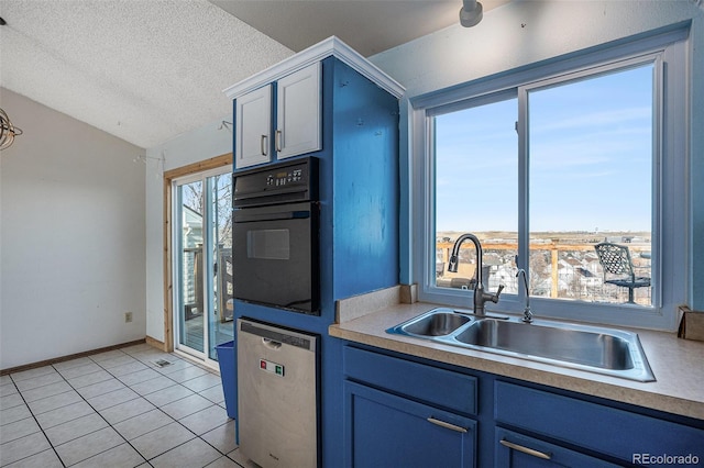 kitchen with stainless steel dishwasher, a textured ceiling, sink, light tile patterned floors, and black oven