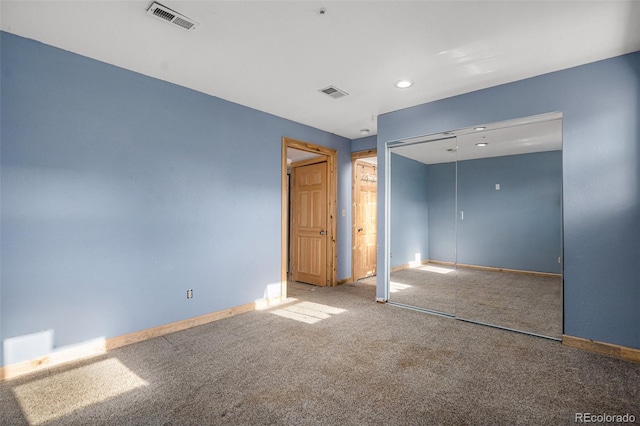 unfurnished bedroom with carpet floors and a closet