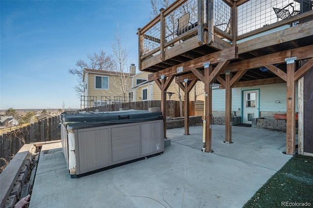 view of patio / terrace featuring a wooden deck and a hot tub