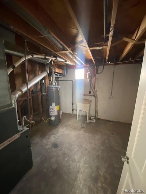basement with gas water heater, sink, and heating unit