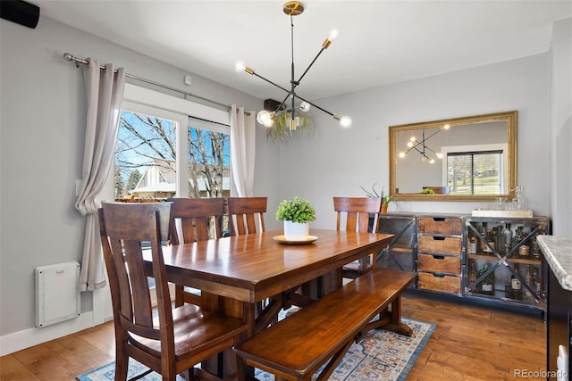 dining room with an inviting chandelier and wood finished floors